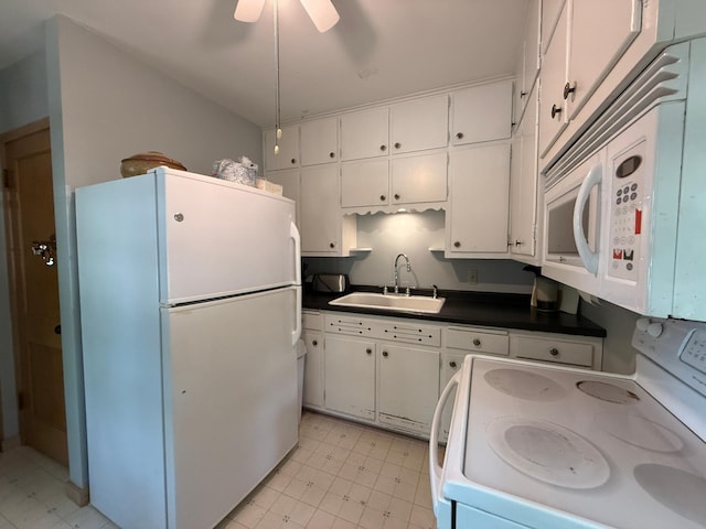 1202 4th St, Montevideo, MN 56265 - kitchen featuring white appliances, white cabinets, dark countertops, and ceiling fan