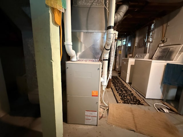1202 4th St, Montevideo, MN 56265 - utility room featuring washing machine and clothes dryer, water heater, and heating unit