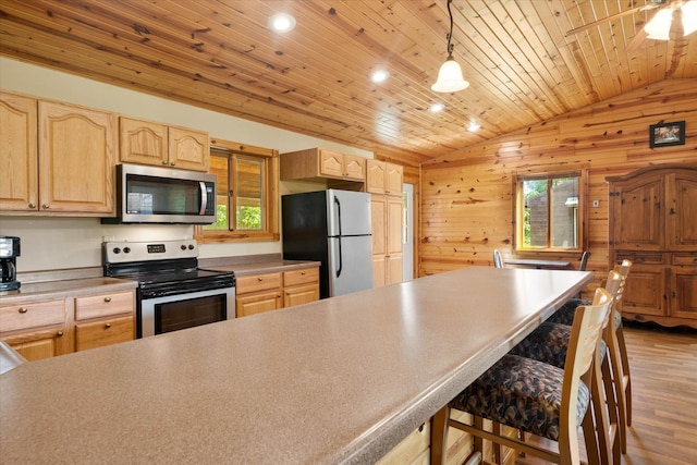 2630 320th St, Cushing, WI 54006 - kitchen with appliances with stainless steel finishes, lofted ceiling, light brown cabinets, light wood-style floors, and a breakfast bar area