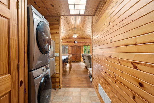 2630 320th St, Cushing, WI 54006 - laundry room featuring stacked washing machine and dryer, wood walls, wood ceiling, and a ceiling fan