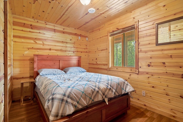 2630 320th St, Cushing, WI 54006 - bedroom with wooden ceiling, dark wood-style floors, and wood walls