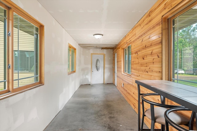2630 320th St, Cushing, WI 54006 - hallway featuring concrete flooring and wooden walls