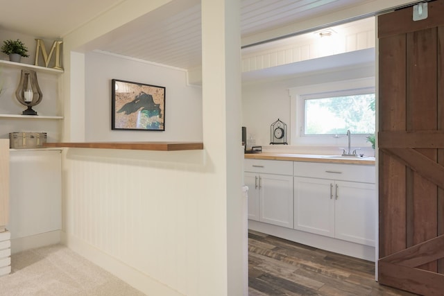 2820 Overlook Dr, Bloomington, MN 55431 - kitchen with open shelves, white cabinets, and wood finished floors