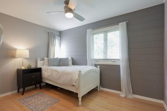 2820 Overlook Dr, Bloomington, MN 55431 - bedroom featuring light wood-type flooring, a ceiling fan, and wooden walls