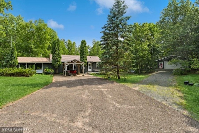 2818 Wilson Ave, Sterling Twp, WI 54024 - ranch-style home featuring asphalt driveway, a front yard, a metal roof, and an outdoor structure