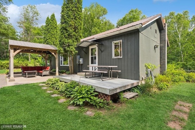 2818 Wilson Ave, Sterling Twp, WI 54024 - back of property with an outdoor hangout area, a gazebo, a yard, and a deck