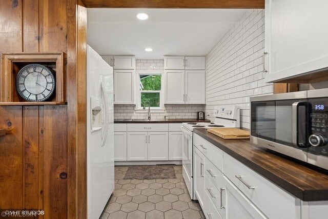 2818 Wilson Ave, Sterling Twp, WI 54024 - kitchen featuring white appliances, backsplash, light tile patterned flooring, white cabinetry, and recessed lighting