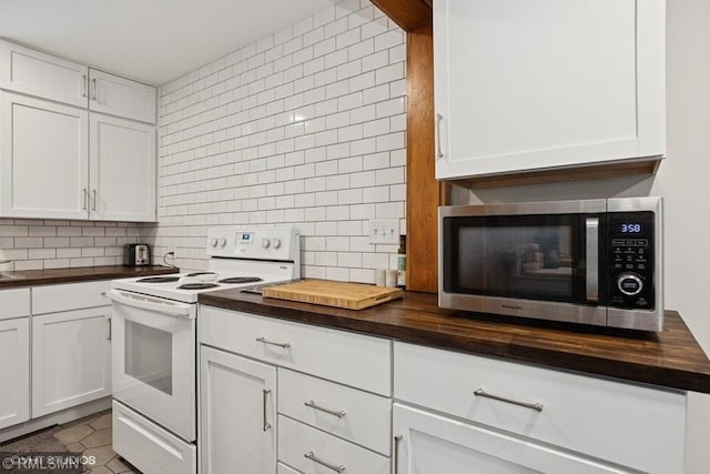 2818 Wilson Ave, Sterling Twp, WI 54024 - kitchen with stainless steel microwave, wooden counters, white electric range oven, and backsplash