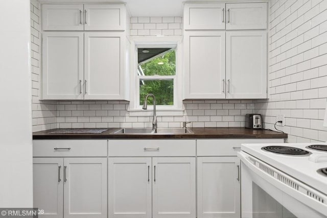 2818 Wilson Ave, Sterling Twp, WI 54024 - kitchen with backsplash, white cabinetry, white range with electric stovetop, and butcher block countertops