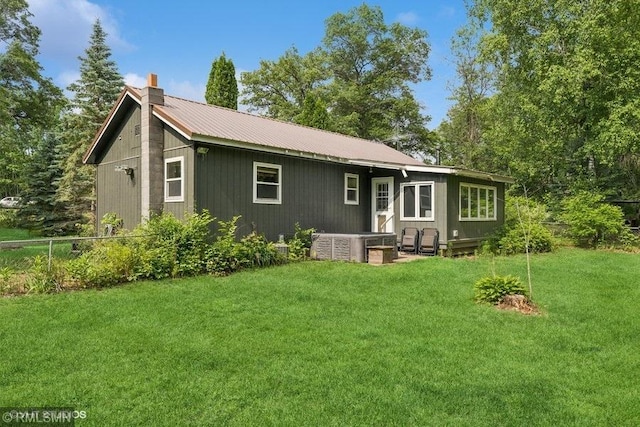 2818 Wilson Ave, Sterling Twp, WI 54024 - rear view of house with a chimney and a metal roof
