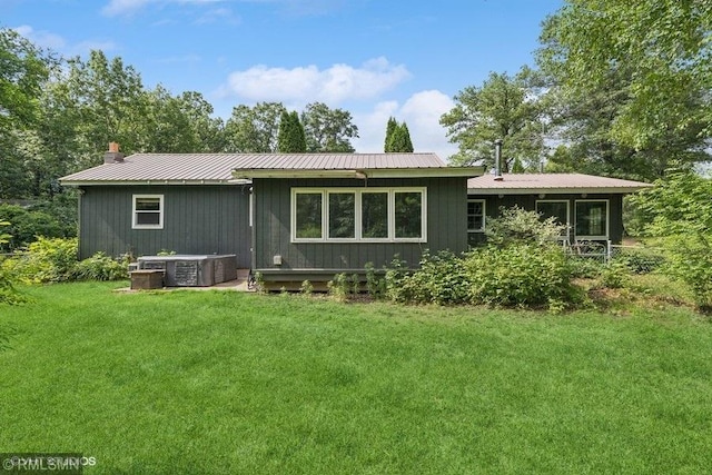 2818 Wilson Ave, Sterling Twp, WI 54024 - rear view of property with a yard, a metal roof, and a chimney