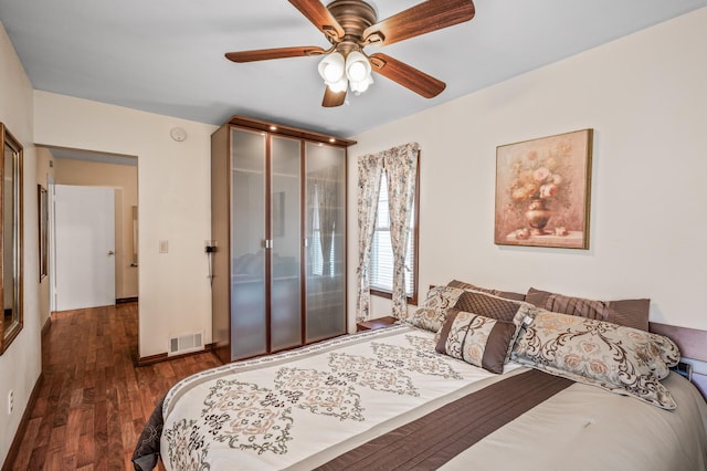 2233 Fremont Ave E, Saint Paul, MN 55119 - bedroom with dark wood-style flooring, a ceiling fan, and a closet
