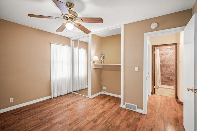 2233 Fremont Ave E, Saint Paul, MN 55119 - unfurnished bedroom featuring wood finished floors, ceiling fan, and a closet