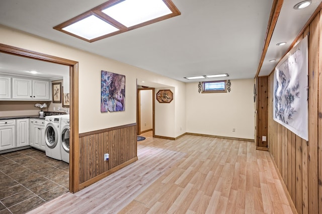 2233 Fremont Ave E, Saint Paul, MN 55119 - laundry area with cabinet space, washer and clothes dryer, wood walls, wood finished floors, and recessed lighting