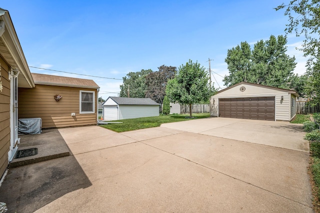 2233 Fremont Ave E, Saint Paul, MN 55119 - view of patio featuring a garage and an outdoor structure