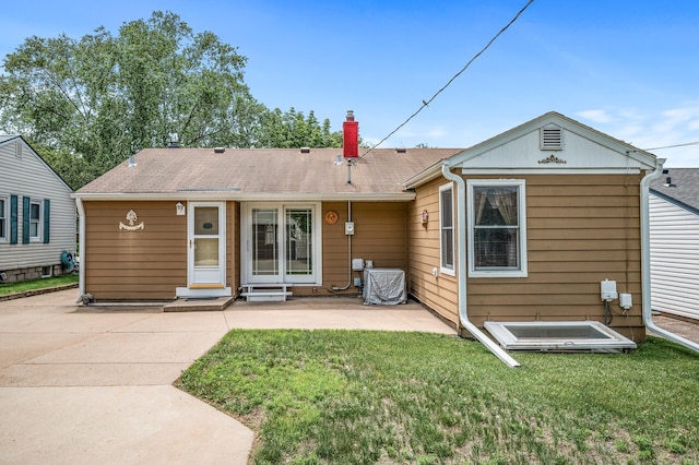 2233 Fremont Ave E, Saint Paul, MN 55119 - back of property featuring a chimney, a lawn, a patio, and a shingled roof