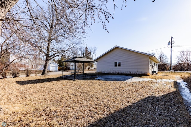 320 Elm St, Crookston, MN 56716 - rear view of property featuring a gazebo, a patio area, and an outdoor structure