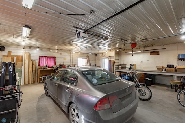 320 Elm St, Crookston, MN 56716 - garage with a garage door opener and a workshop area