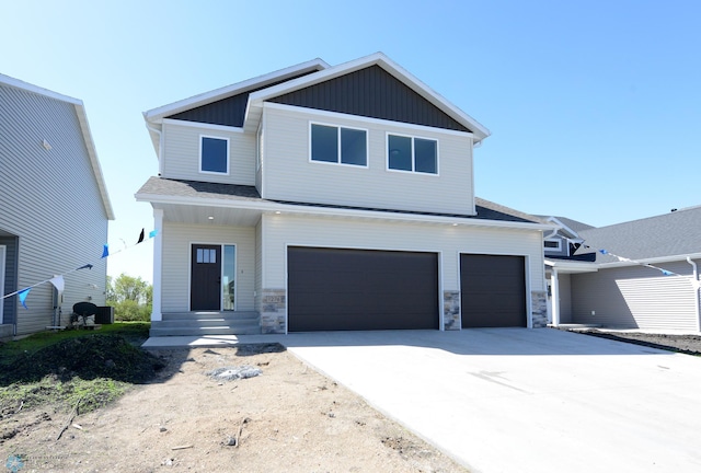 1276 Marlys Dr W, West Fargo, ND 58078 - view of front of home with a garage, board and batten siding, concrete driveway, stone siding, and roof with shingles
