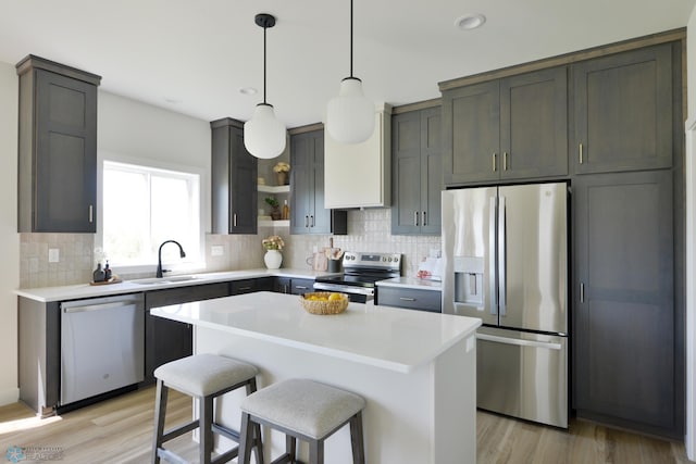 1276 Marlys Dr W, West Fargo, ND 58078 - kitchen with stainless steel appliances, tasteful backsplash, light wood finished floors, light countertops, and recessed lighting