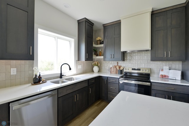 1276 Marlys Dr W, West Fargo, ND 58078 - kitchen with stainless steel appliances, open shelves, wood finished floors, and light countertops