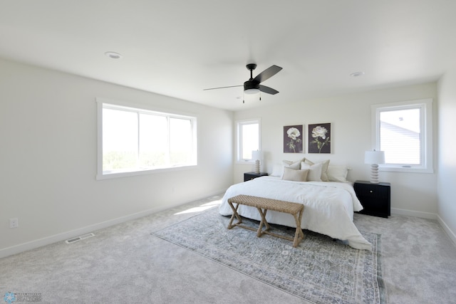 1276 Marlys Dr W, West Fargo, ND 58078 - bedroom with multiple windows, light carpet, and a ceiling fan