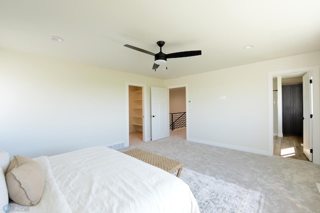 1276 Marlys Dr W, West Fargo, ND 58078 - bedroom featuring light colored carpet, a spacious closet, and ceiling fan