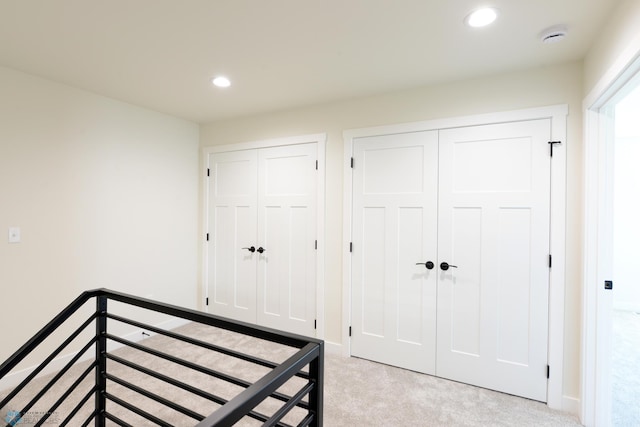 1276 Marlys Dr W, West Fargo, ND 58078 - unfurnished bedroom with multiple closets, light colored carpet, and recessed lighting