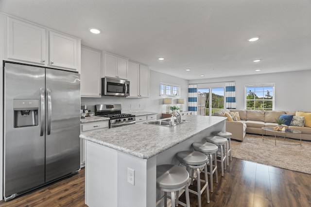 7558 Woods Edge Blvd, Lino Lakes, MN 55014 - kitchen featuring stainless steel appliances, dark wood finished floors, white cabinetry, healthy amount of natural light, and recessed lighting