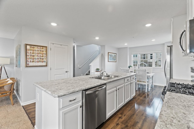 7558 Woods Edge Blvd, Lino Lakes, MN 55014 - kitchen with stainless steel appliances, dark wood-style flooring, white cabinetry, recessed lighting, and a center island with sink