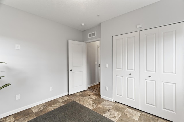 7558 Woods Edge Blvd, Lino Lakes, MN 55014 - unfurnished bedroom with stone finish flooring and a closet