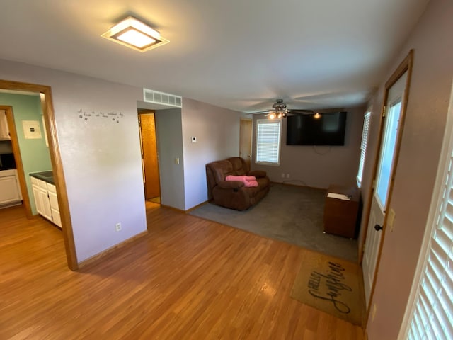 108 20th St S, Benson, MN 56215 - unfurnished living room featuring light wood-type flooring and ceiling fan