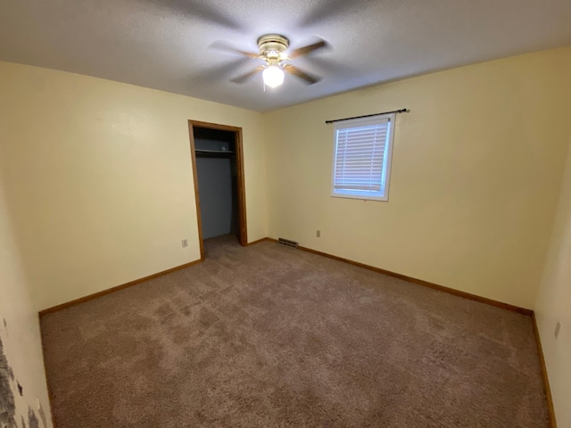 108 20th St S, Benson, MN 56215 - unfurnished bedroom with carpet, a closet, and a ceiling fan