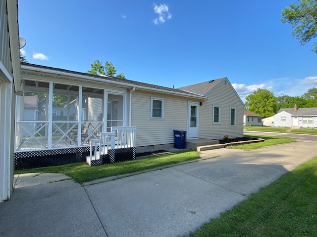 108 20th St S, Benson, MN 56215 - view of home's exterior featuring crawl space, a sunroom, and roof with shingles