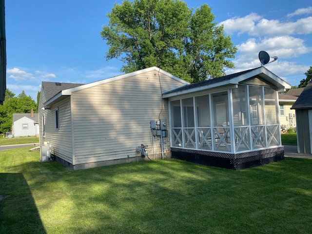 108 20th St S, Benson, MN 56215 - back of house featuring a sunroom and a lawn