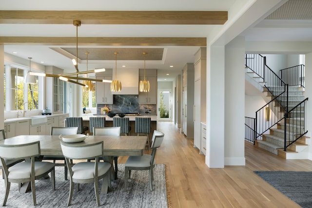 1038 Lake St E, Wayzata, MN 55391 - dining space featuring beamed ceiling, stairway, light wood finished floors, a chandelier, and recessed lighting