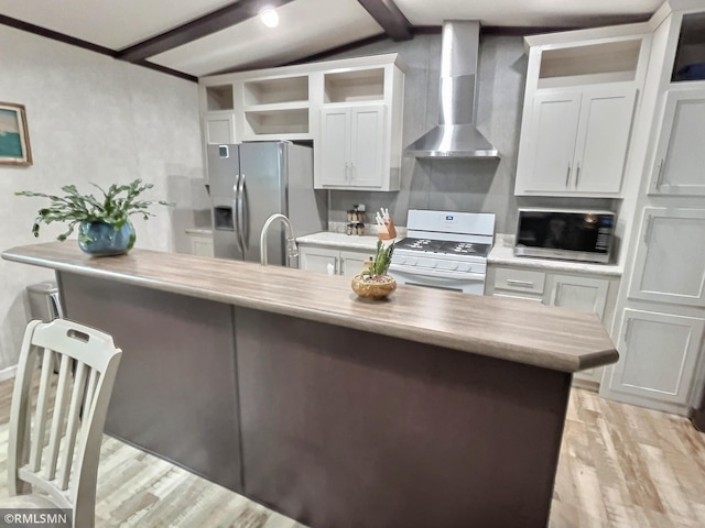13648 Campfire Cir, South Haven, MN 55382 - kitchen featuring wall chimney exhaust hood, appliances with stainless steel finishes, a kitchen breakfast bar, light wood-style floors, and lofted ceiling