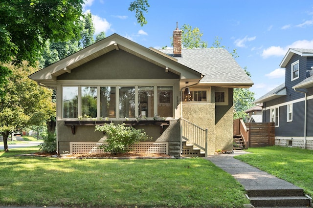 1339 Sargent Ave, Saint Paul, MN 55105 - view of front facade featuring a chimney, stucco siding, a front lawn, a sunroom, and a shingled roof