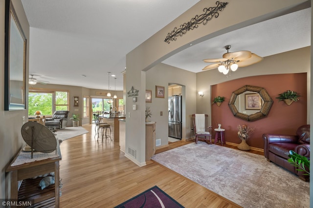 6831 Centerville Rd, Centerville, MN 55038 - living room with ceiling fan, light wood-style floors, and arched walkways