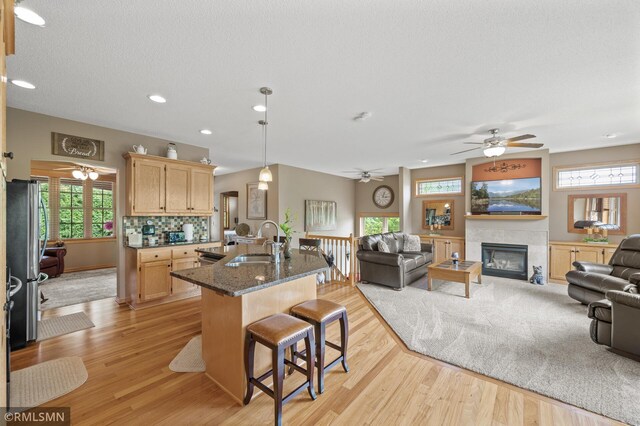 6831 Centerville Rd, Centerville, MN 55038 - kitchen featuring light brown cabinets, freestanding refrigerator, open floor plan, light wood-style floors, and recessed lighting