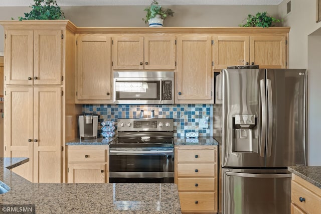 6831 Centerville Rd, Centerville, MN 55038 - kitchen featuring stainless steel appliances, light brown cabinetry, decorative backsplash, and dark stone counters