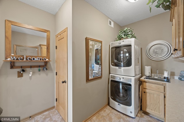 6831 Centerville Rd, Centerville, MN 55038 - washroom with estacked washer and dryer, cabinet space, a textured ceiling, light tile patterned flooring, and bar with sink