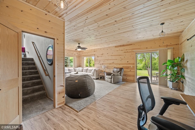 6831 Centerville Rd, Centerville, MN 55038 - living area featuring wood walls, wooden ceiling, light wood-style flooring, stairway, and ceiling fan