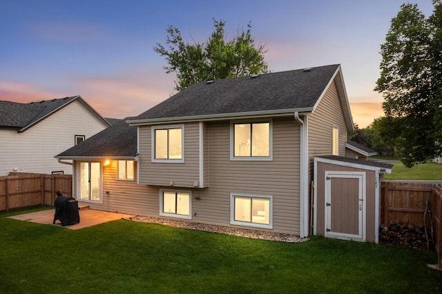 3872 Westbury Ln, Eagan, MN 55123 - back of property with a fenced backyard, a patio, a shingled roof, and an outbuilding