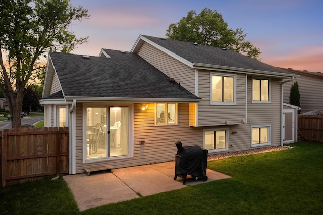 3872 Westbury Ln, Eagan, MN 55123 - back of property at dusk featuring a shingled roof and a patio