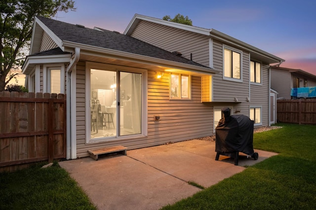 3872 Westbury Ln, Eagan, MN 55123 - back of property at dusk with a patio area and roof with shingles
