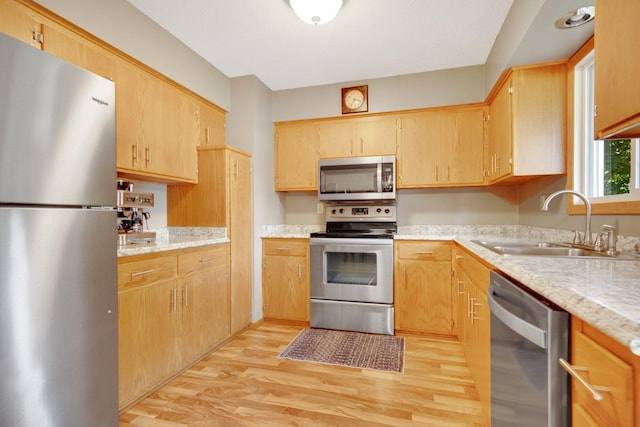124 Willow Dr SW, Saint Michael, MN 55376 - kitchen with stainless steel appliances, light wood-style flooring, and light stone counters
