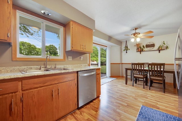 124 Willow Dr SW, Saint Michael, MN 55376 - kitchen with stainless steel dishwasher, light countertops, light wood-type flooring, and a ceiling fan