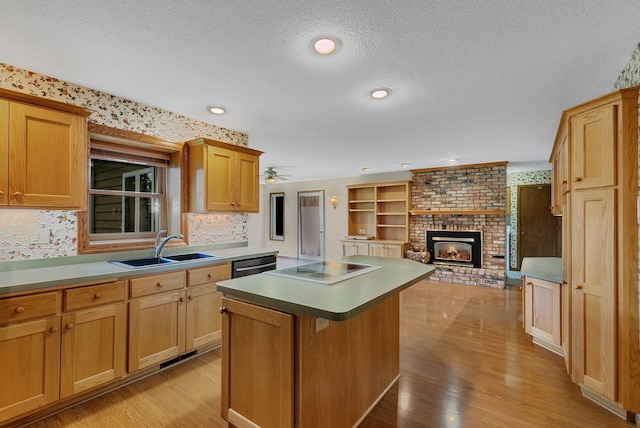 1044 Borgert Ave, Saint Cloud, MN 56303 - kitchen with a center island, electric stovetop, light wood-style flooring, a textured ceiling, and ceiling fan