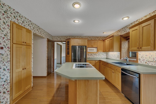 1044 Borgert Ave, Saint Cloud, MN 56303 - kitchen featuring appliances with stainless steel finishes, wallpapered walls, light wood-style flooring, a center island, and light countertops